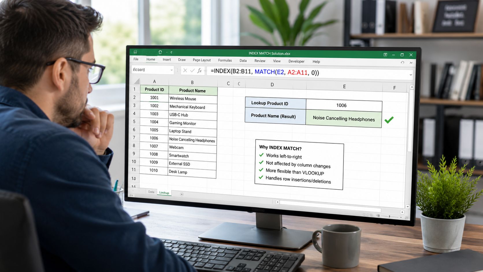 A person sitting at a desk looking at a computer screen displaying an Excel spreadsheet with INDEX MATCH formulas.